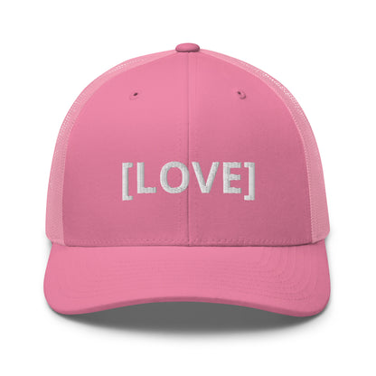 Pink trucker cap with the word 'LOVE' embroidered in white within brackets, symbolizing an inclusive message, featuring a mesh back and available in multiple colors.