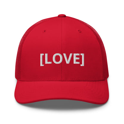 Red trucker cap with the word 'LOVE' embroidered in white within brackets, symbolizing an inclusive message, featuring a mesh back and available in multiple colors.