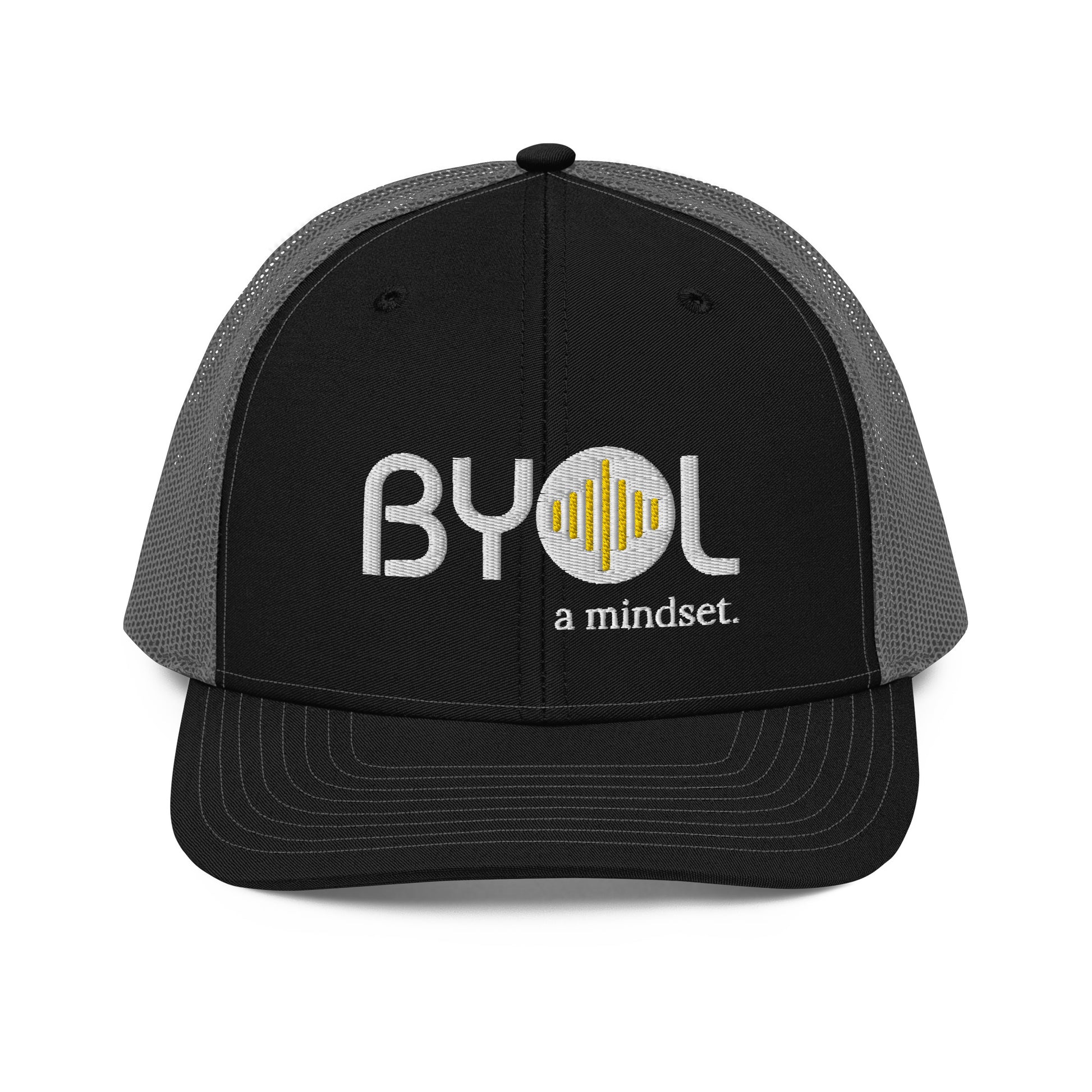 Black and grey pre-curved contrast stitched trucker hat with "BYOL a mindset" embroidered on the front in white and yellow, displayed against a clean background. Available in various colors: maroon, black, green, and gray.