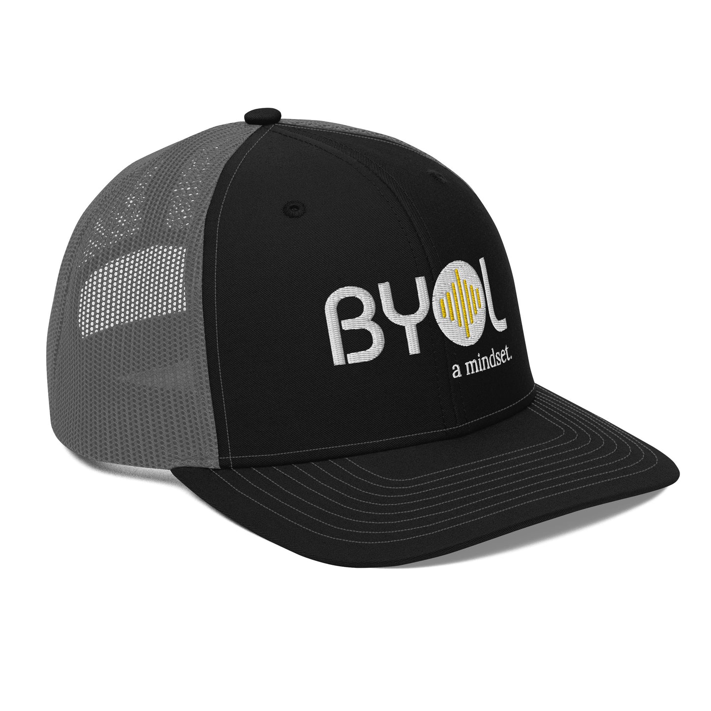 Black and gray pre-curved contrast stitched trucker hat with "BYOL a mindset" embroidered on the front in white and yellow displayed against a clean background. Available in various colors: maroon, black, green, and gray.