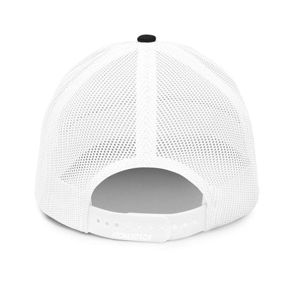 A rear view of a white snapback trucker cap, showcasing a mesh back for breathability and an adjustable plastic snap closure for a customizable fit. The cap has a gray underbill, and the brand "RICHARDSON" is embossed on the back panel above the snapback.