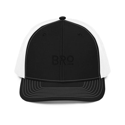 A black and white  snapback trucker cap with the letters "BRO" in bold black font centered on the front panel. This cap features a curved brim, black mesh back panels for enhanced airflow, and an adjustable snap closure ensuring a snug and comfortable fit.