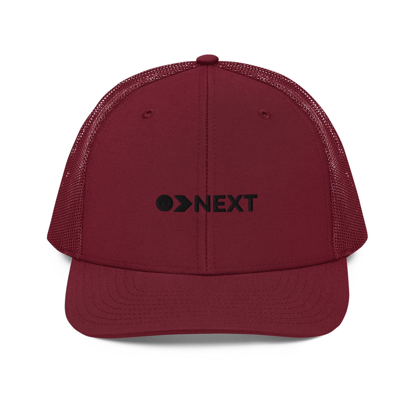 A maroon snapback trucker cap featuring a front panel with a black embroidered logo that reads "NEXT" with an eye-like symbol as the 'E.' The cap has a curved brim and breathable mesh panels on the sides and back, complete with a button top and adjustable strap for a versatile fit.