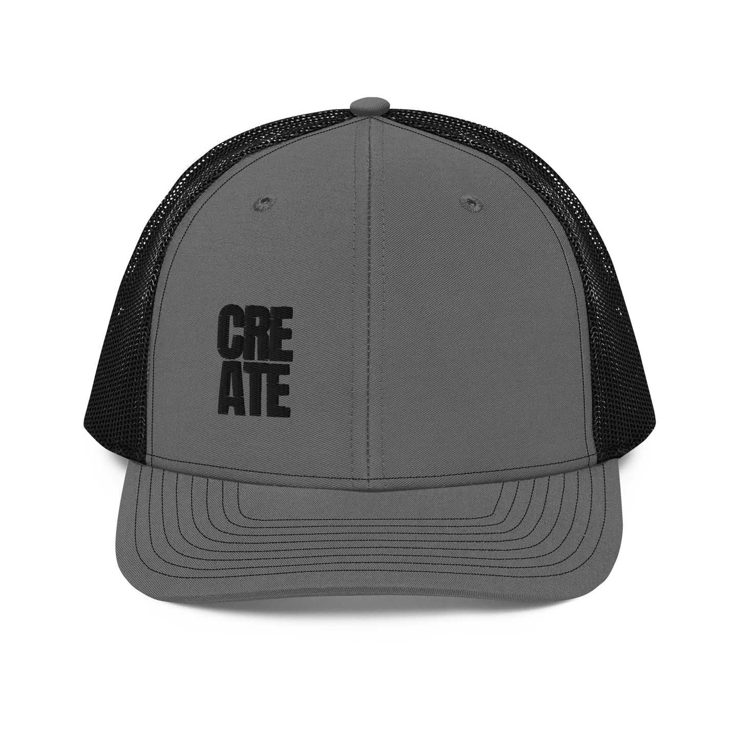 A charcoal gray snapback trucker cap with the word "CREATE" in bold black letters divided across the front panel. It features a pre-curved visor, a structured front crown, black mesh back panels for breathability, and an adjustable snap closure to fit various head sizes comfortably.