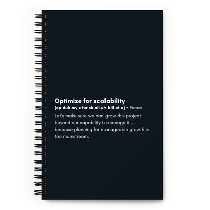 A black spiral-bound notebook featuring a humorous definition of the business term "Optimize for scalability" in white lettering on the cover.