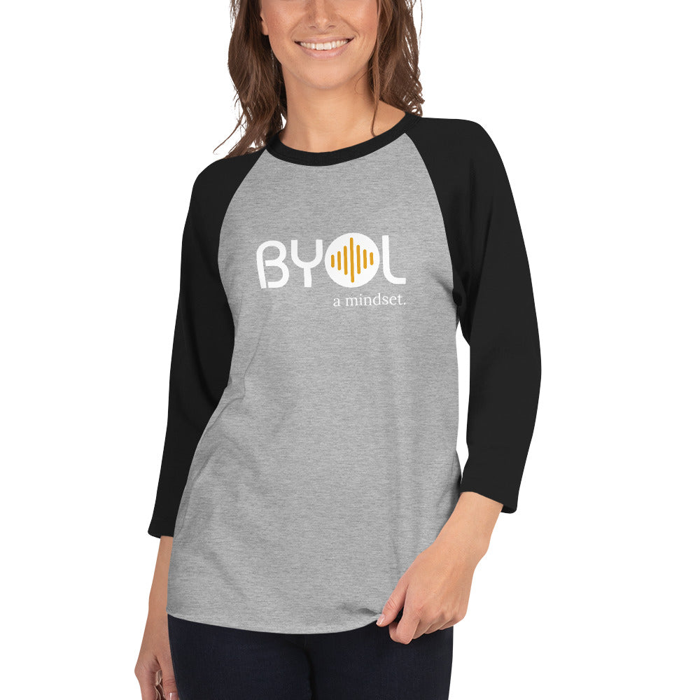 Woman wearing a gray and black BYOL mindset raglan t-shirt with color options in red, gray, black, white, and green, available in sizes S to 3XL.