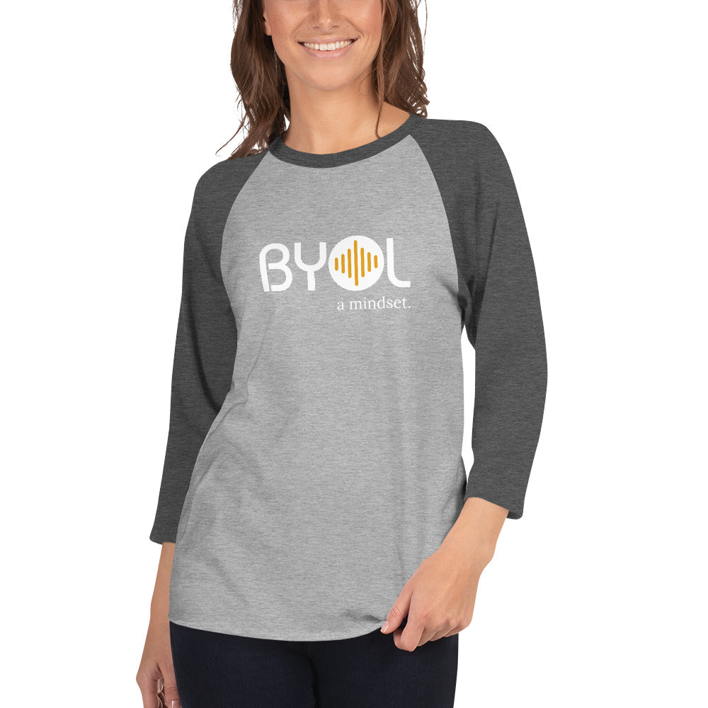 Woman wearing a gray and grey BYOL mindset raglan t-shirt with color options in red, gray, black, white, and green, available in sizes S to 3XL.