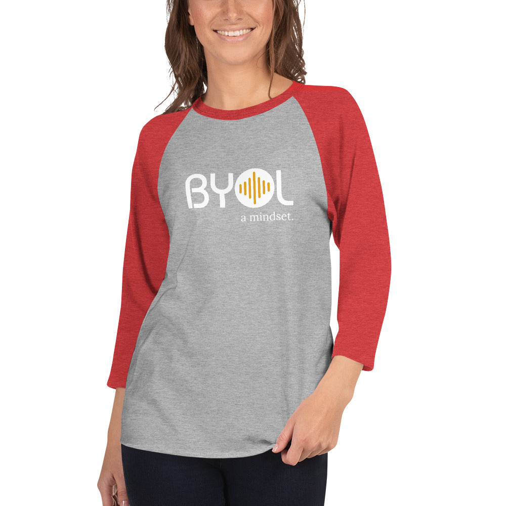 Woman wearing a gray and red BYOL mindset raglan t-shirt with color options in red, gray, black, white, and green, available in sizes S to 3XL.