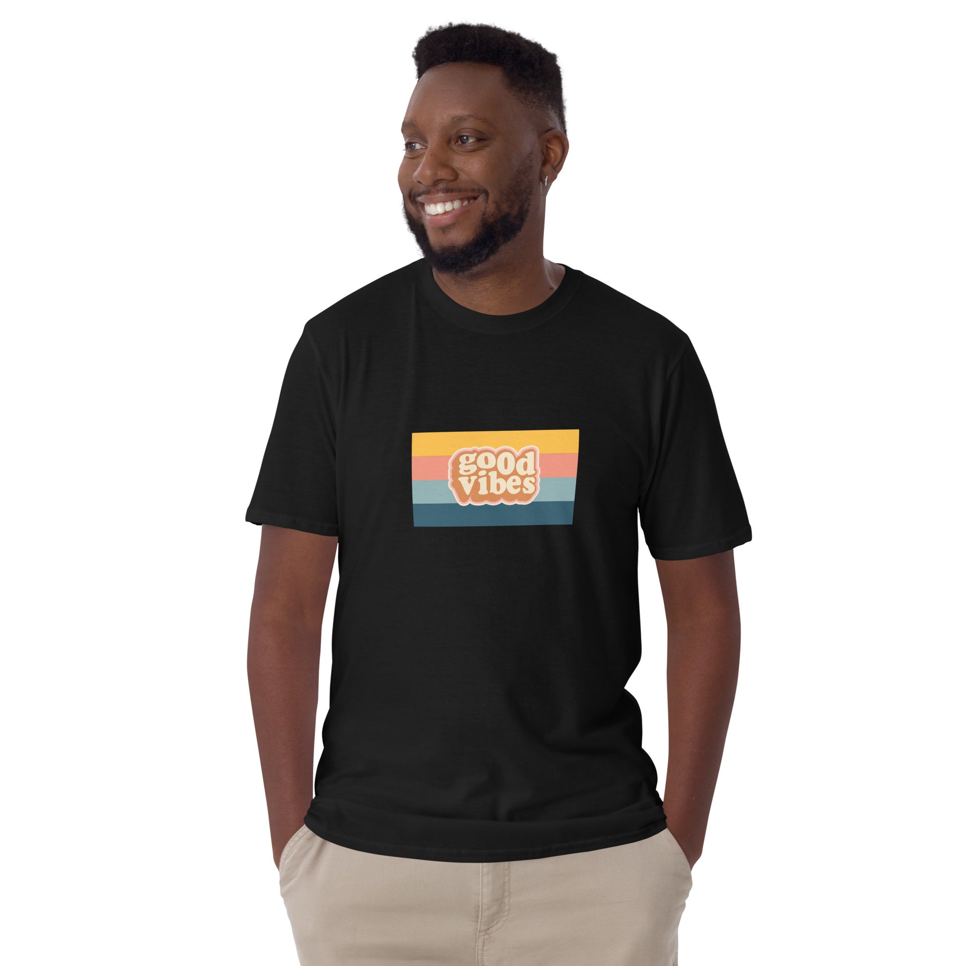 Smiling man in a black 'Good Vibes' retro t-shirt, blending inspirational style with soft comfort