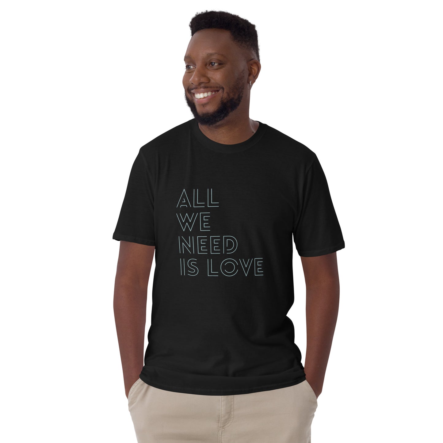 Man in a black 'All We Need Is Love' soft cotton t-shirt, ideal for both self-expression and gifting