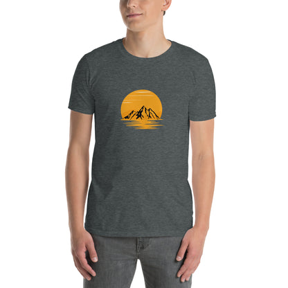 Man wearing a heather grey soft cotton t-shirt with a mountain sunset design, perfect for inspiring bold self-expression