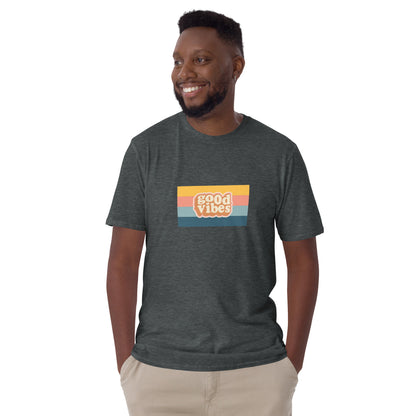 Smiling man in a heather grey 'Good Vibes' retro t-shirt, blending inspirational style with soft comfort