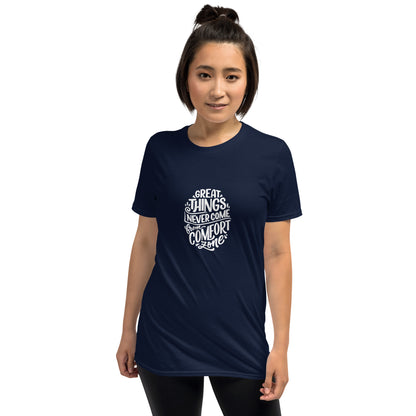 A woman with a confident stance is wearing a navy blue t-shirt featuring the motivational quote "Great things never come from comfort zones" in white stylized text, inspiring action and bravery.