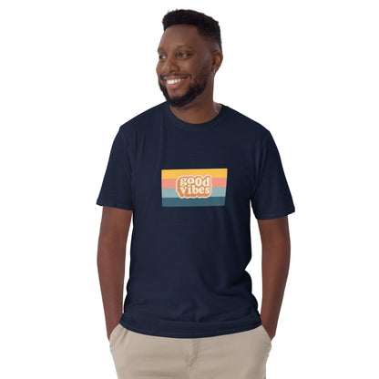 Smiling man in a navy blue 'Good Vibes' retro t-shirt, blending inspirational style with soft comfort