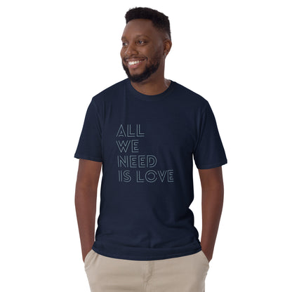 Man in a navy blue 'All We Need Is Love' soft cotton t-shirt, ideal for both self-expression and gifting