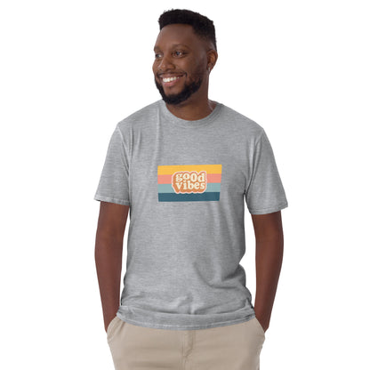 Smiling man in a sport grey 'Good Vibes' retro t-shirt, blending inspirational style with soft comfort