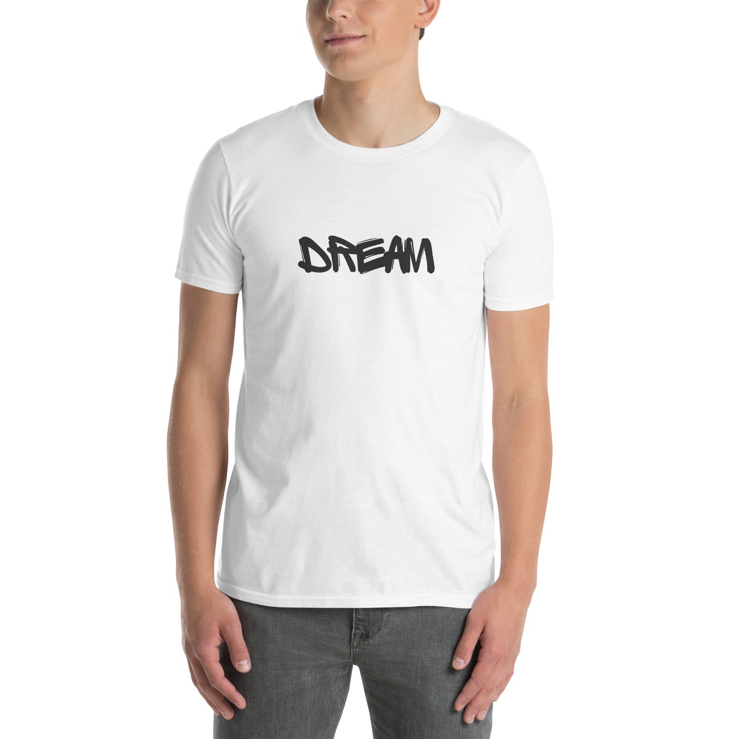 A young man is wearing a white t-shirt with the word "DREAM" written in a freehand, black font across the chest, conveying a message of hope and ambition.