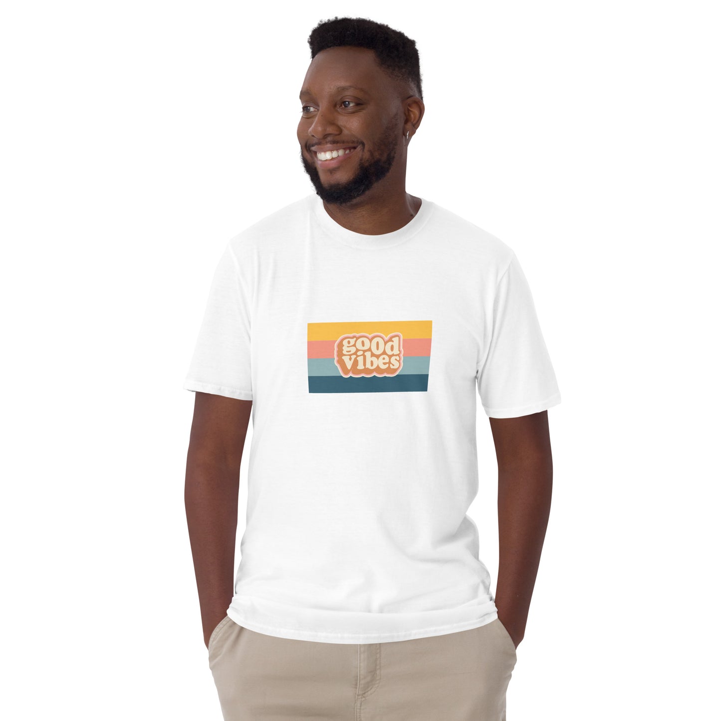 Smiling man in a white 'Good Vibes' retro t-shirt, blending inspirational style with soft comfort