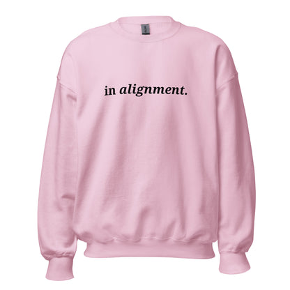 Pink sweatshirt with the phrase "in alignment." printed on the front, available in color options navy blue, green, maroon, gray, and pink, available in sizes S to 3XL.