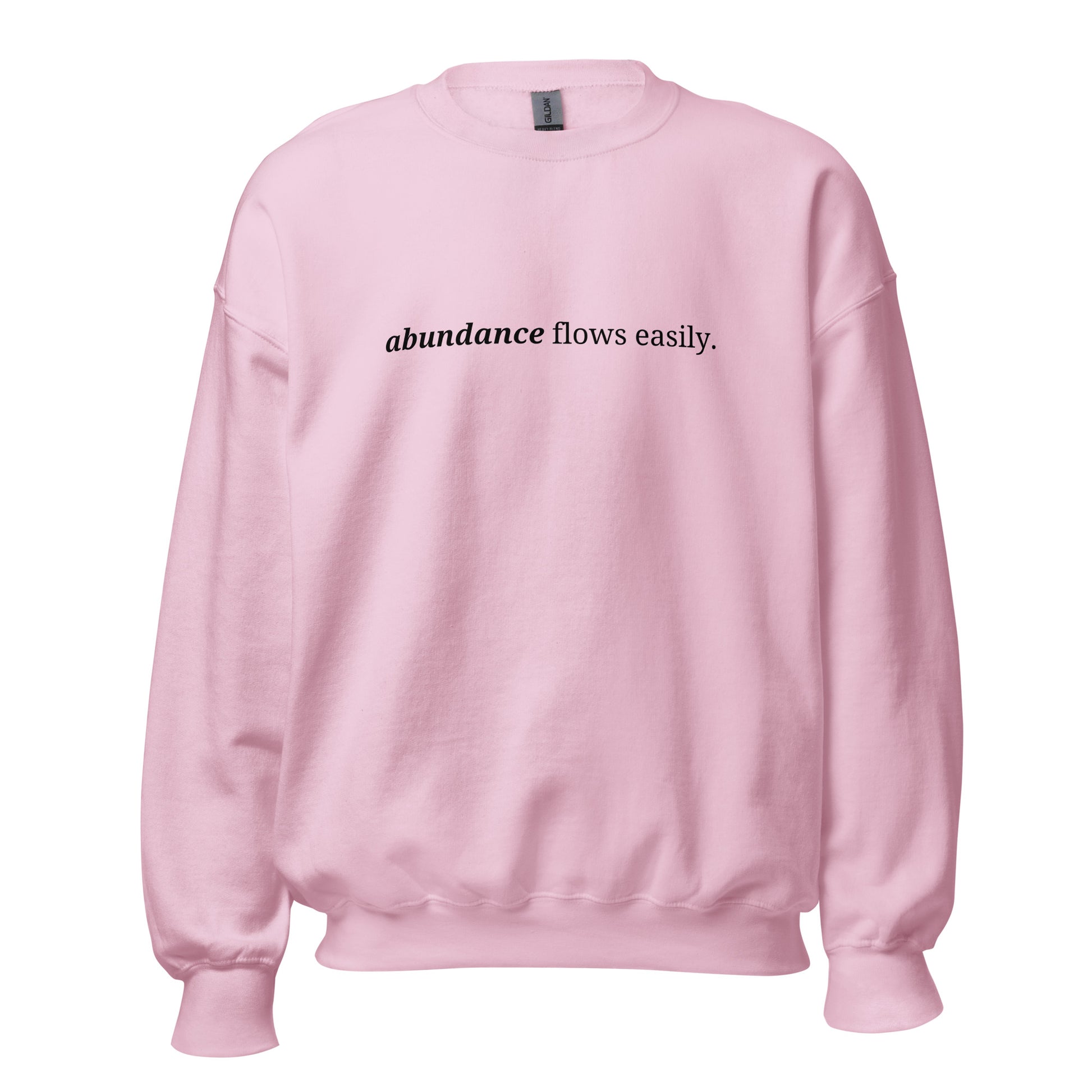 Pink sweatshirt with the phrase "abundance flows easily." printed on the front, available in color options navy blue, green, maroon, gray, and pink, available in sizes S to 3XL.