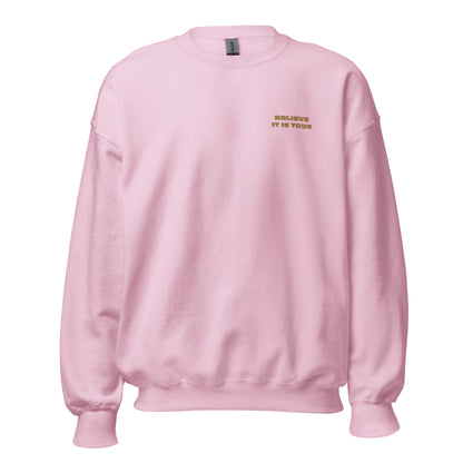 Pink "Believe It Is True" premium crew neck sweatshirt with ribbed cuffs, soft fleece lining, and comfortable fit.