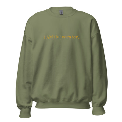 Military green sweatshirt with the phrase "I AM the creator." printed on the front, available in color options navy blue, green, maroon, gray, and pink, available in sizes S to 3XL.