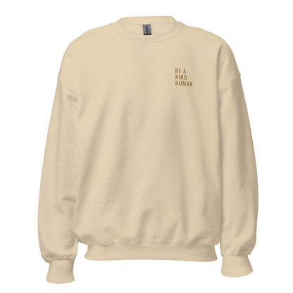 Sand "Be A Kind Human" premium crew neck sweatshirt with ribbed cuffs, soft fleece lining, and comfortable fit.