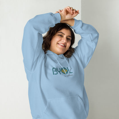 Woman wearing a light blue BYOL mindset hoodie with color options in black, maroon, olive green, and gray, available in sizes S to 5XL.