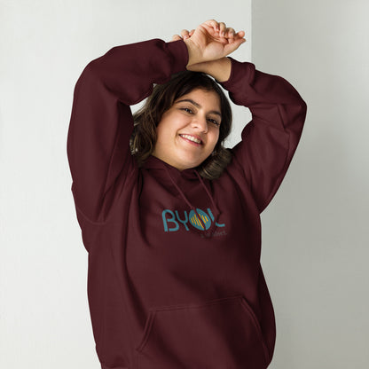 Woman wearing a maroon BYOL mindset hoodie with color options in black, maroon, olive green, and gray, available in sizes S to 5XL.