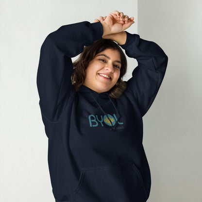 Woman wearing a navy blue BYOL mindset hoodie with color options in black, maroon, olive green, and gray, available in sizes S to 5XL.