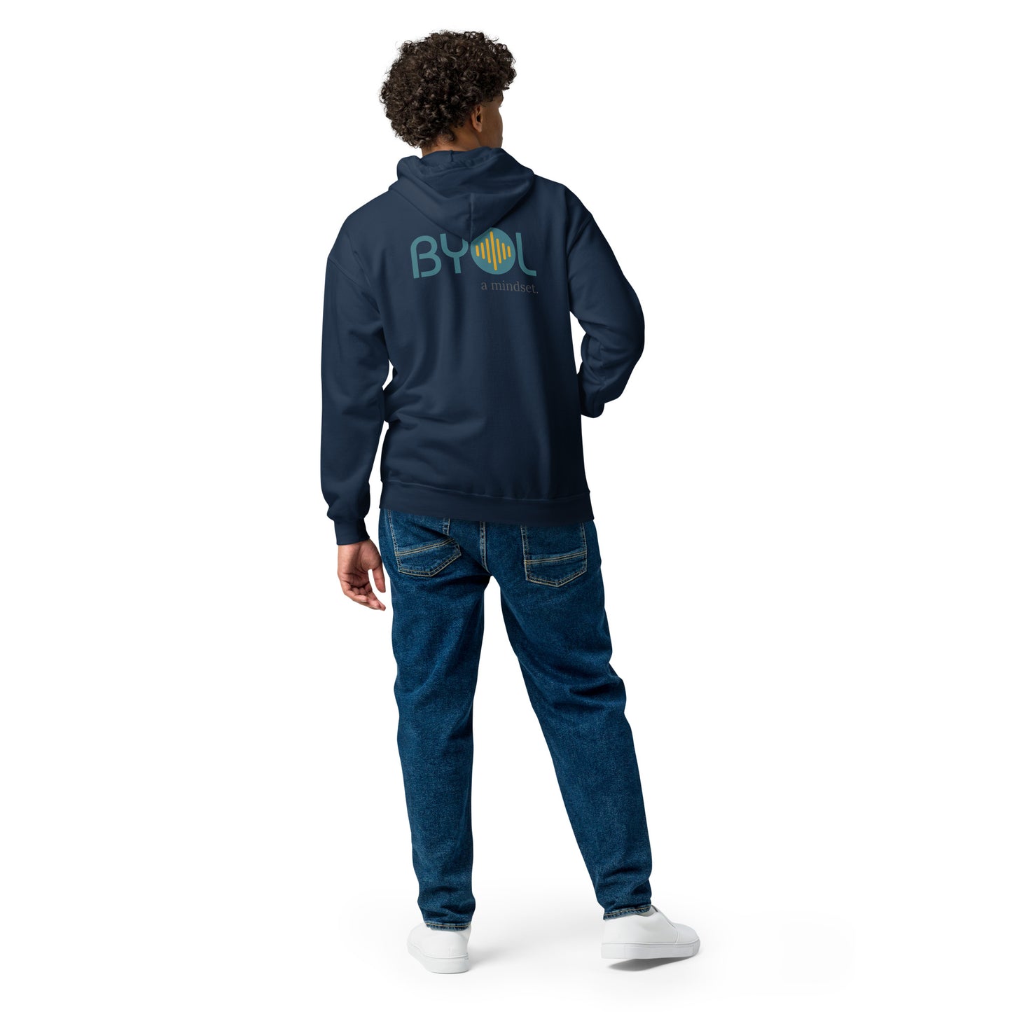 A young man with curly hair wearing a navy blue "BYOL: a mindset" hoodie, viewed from the back. The hoodie features the "BYOL" logo in teal and yellow on the back and is available in multiple colors (black, gray, navy, white, plus more) and sizes (S-3XL). The "be you out loud" logo is displayed at the top.