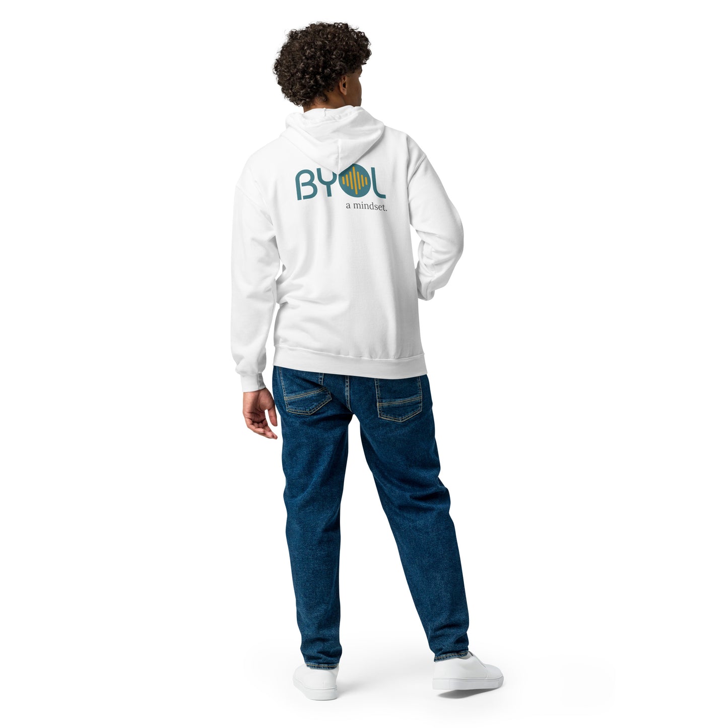 A young man with curly hair wearing a white "BYOL: a mindset" hoodie, viewed from the back. The hoodie features the "BYOL" logo in teal and yellow on the back and is available in multiple colors (black, gray, navy, white, plus more) and sizes (S-3XL). The "be you out loud" logo is displayed at the top.