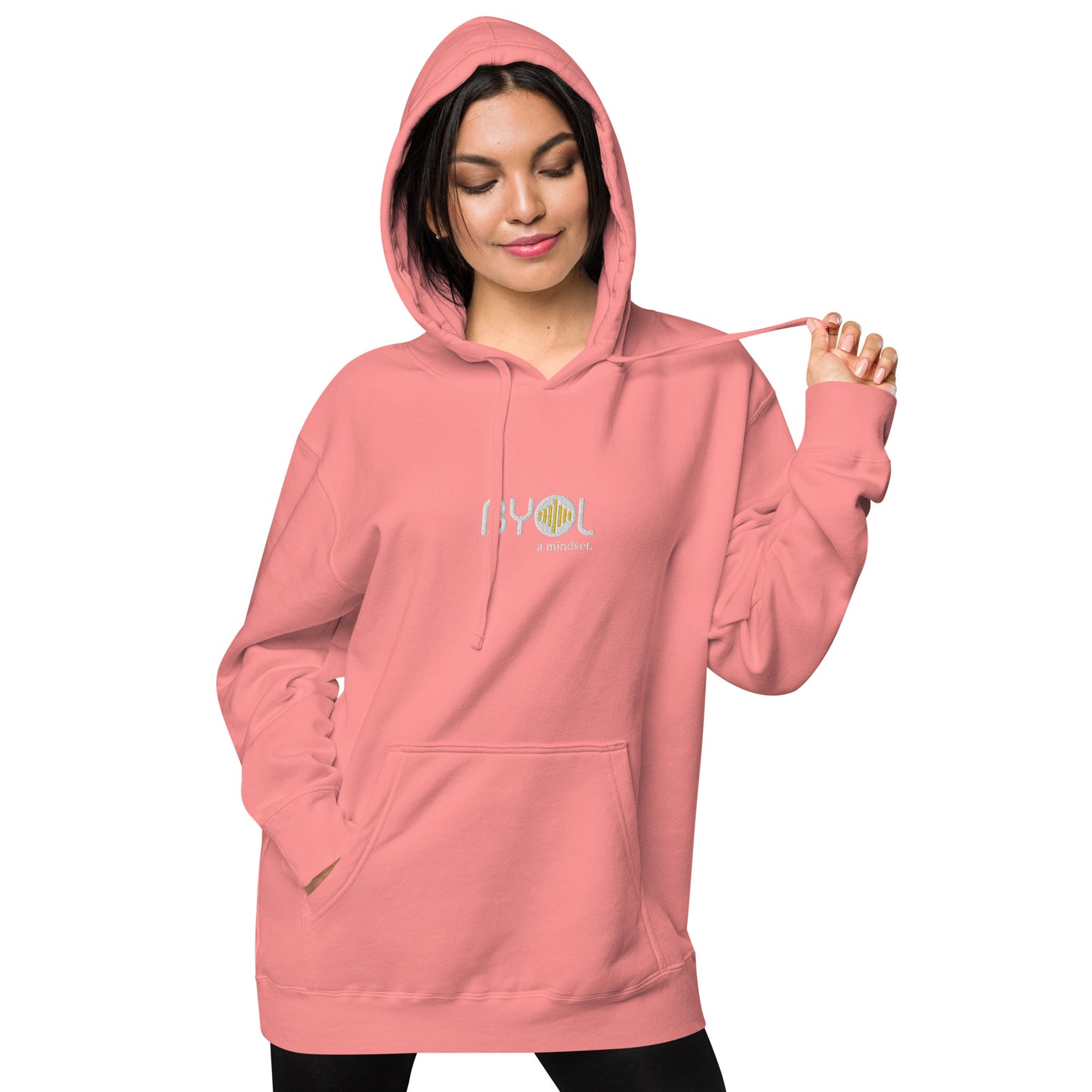 Woman wearing a pigmented pink BYOL mindset hoodie with color options in brown, pink, gray, and green, available in sizes S to 2XL.