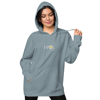 Woman wearing a pigmented blue BYOL mindset hoodie with color options in brown, pink, gray, and green, available in sizes S to 2XL.