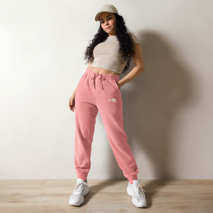 Close-up of a woman wearing pigment pink BYOL mindset joggers with color options in brown, green, pink, and blue, available in sizes S to 3XL.