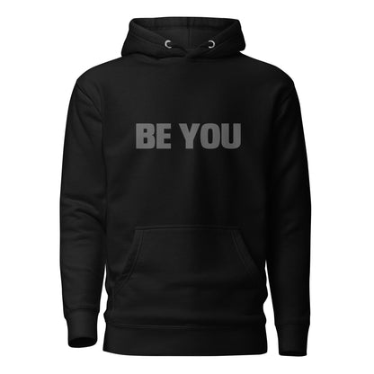 Black "Be You" printed premium hoodie with front pouch pocket, adjustable drawstrings, and soft fleece lining.