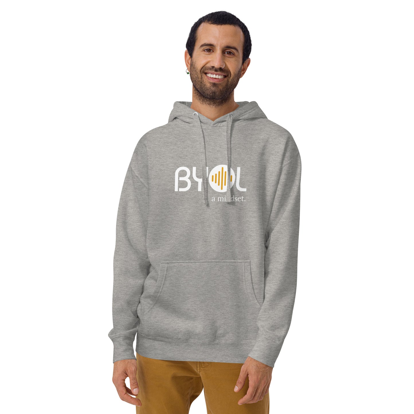 A young man with short hair and a beard wearing a light heather grey "BYOL: a mindset" hoodie, smiling and standing with his arms at his sides. The hoodie features the "BYOL" logo in white and yellow on the front and is available in multiple colors (black, dark gray, maroon, pink, light gray, plus more) and sizes (S-3XL). The "be you out loud" logo is displayed at the top.