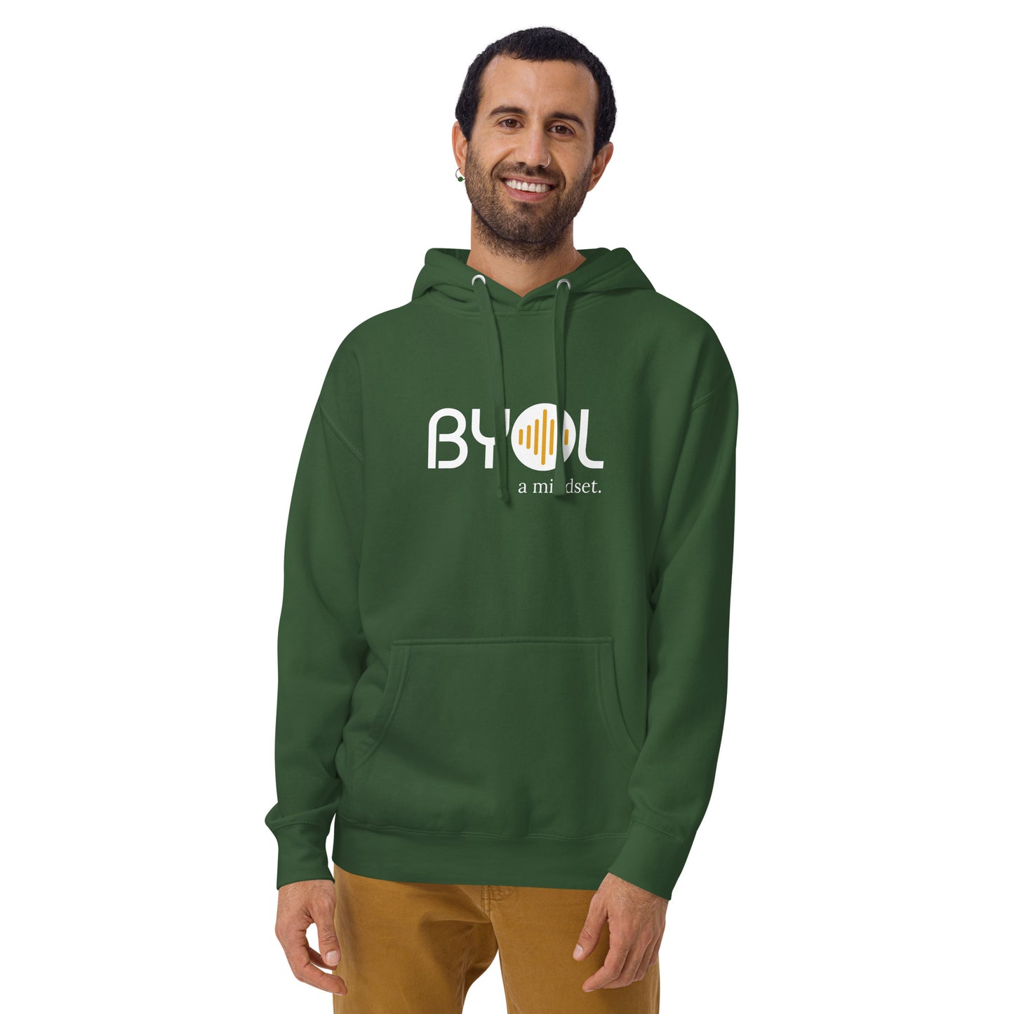 A young man with short hair and a beard wearing a green "BYOL: a mindset" hoodie, smiling and standing with his arms at his sides. The hoodie features the "BYOL" logo in white and yellow on the front and is available in multiple colors (black, dark gray, maroon, pink, light gray, plus more) and sizes (S-3XL). The "be you out loud" logo is displayed at the top.