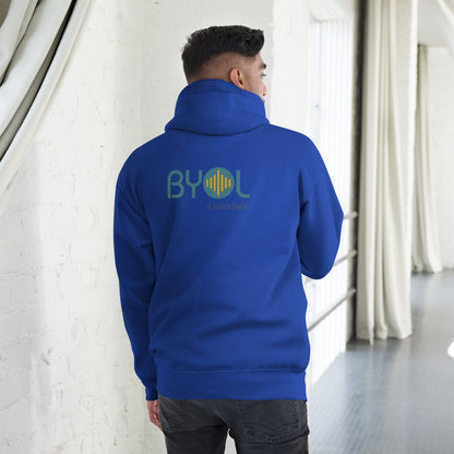 A young man wearing a royal blue "BYOL: a mindset" hoodie, viewed from the back. The hoodie features the "BYOL" logo in teal and yellow on the back and is available in multiple colors (black, red, maroon, brown, plus more) and sizes (S-3XL). The "be you out loud" logo is displayed at the top.