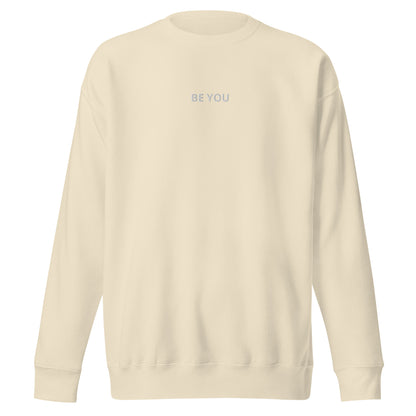 sand embroidered "Be You" premium crew neck sweatshirt with soft fleece interior, ribbed cuffs, and hem.