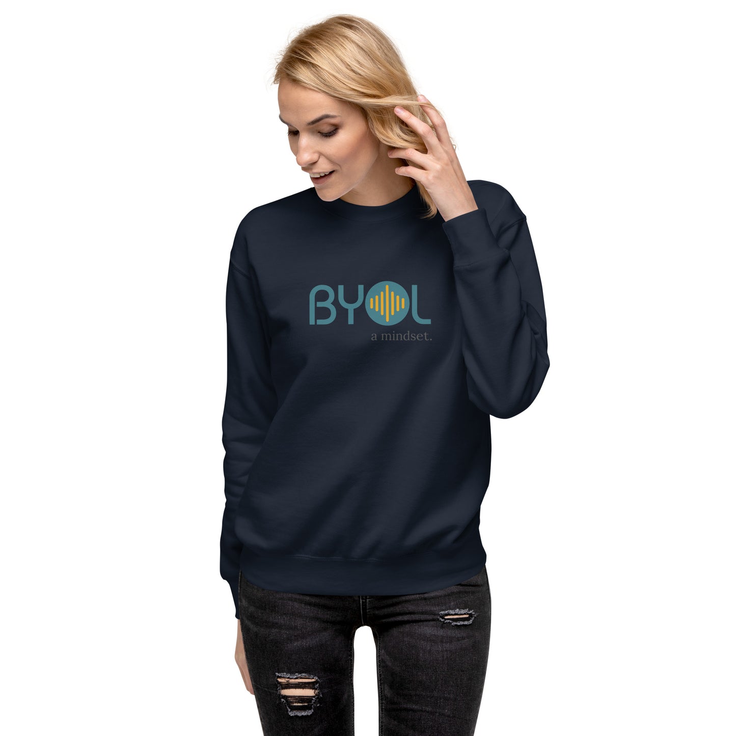 Woman wearing a navy blue BYOL mindset sweatshirt with color options in black, dark gray, pink, and light gray, available in sizes S to 2XL.