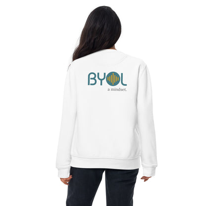 Back view of a woman wearing a white BYOL mindset sweatshirt with color options in black, dark gray, pink, and light gray, available in sizes S to 2XL.