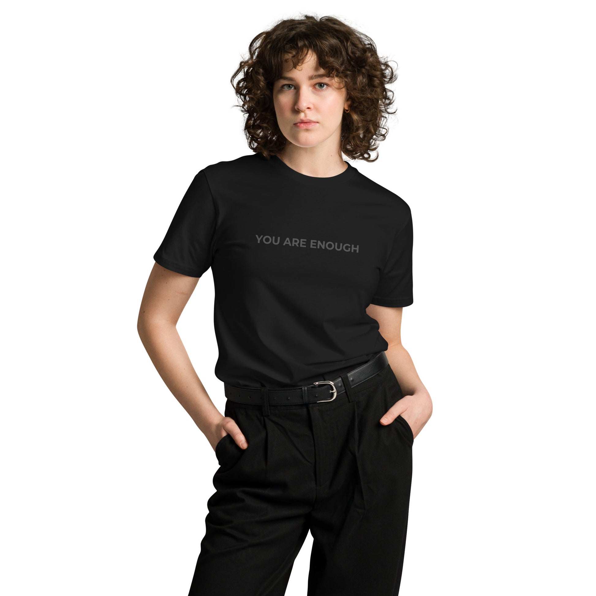 Woman wearing a black premium tee with "You Are Enough" text.