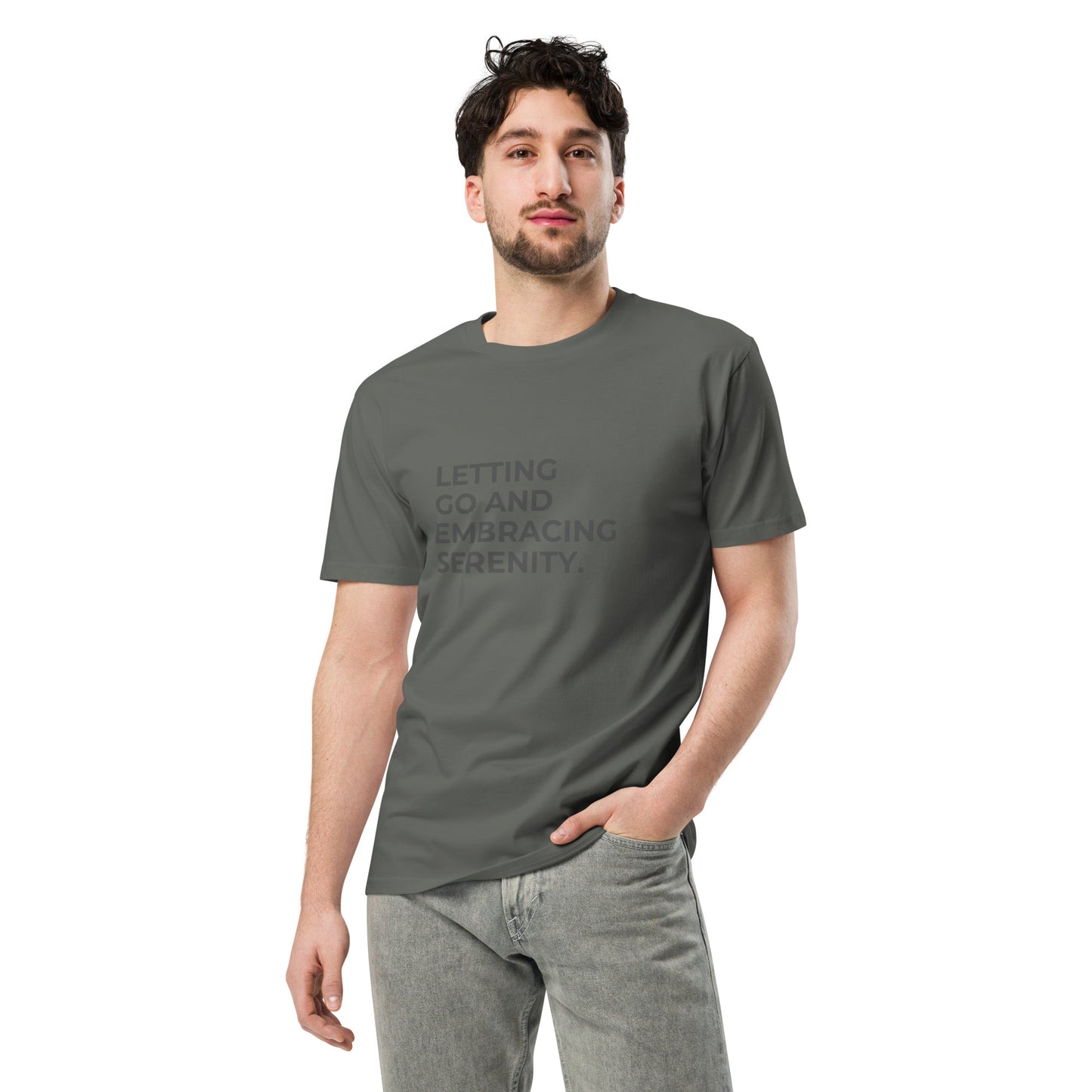 Man wearing a charcoal premium tee with the text "Letting Go and Embracing Serenity".