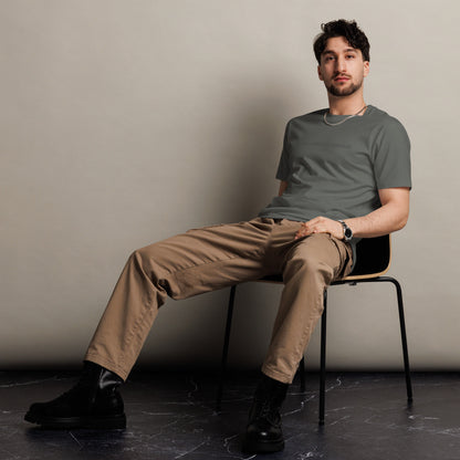 Man sitting wearing a charcoal premium tee with the text "Building My Dreams".