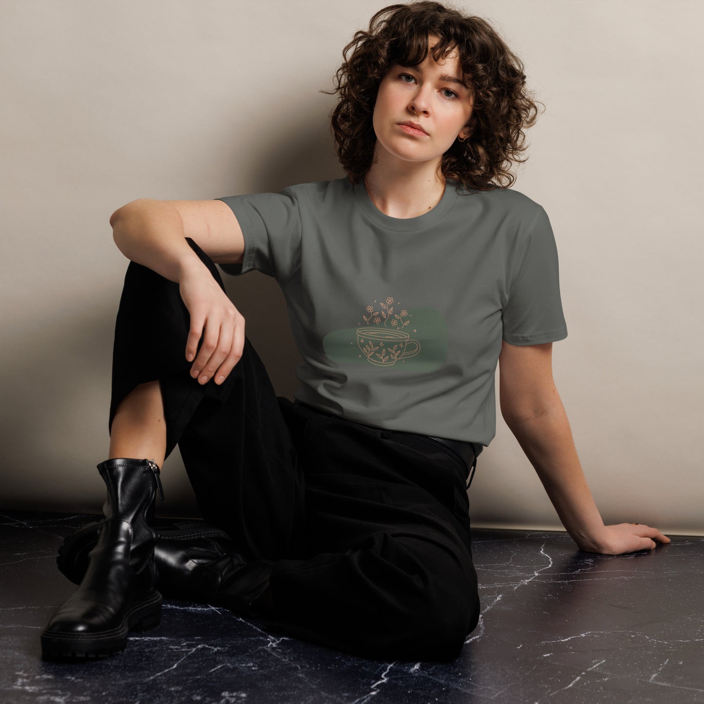 Women's Premium Charcoal Tee with a serene teacup design, featuring a muted illustration of a teacup with flowers on a cream tee, perfect for subtle self-expression and tranquility.