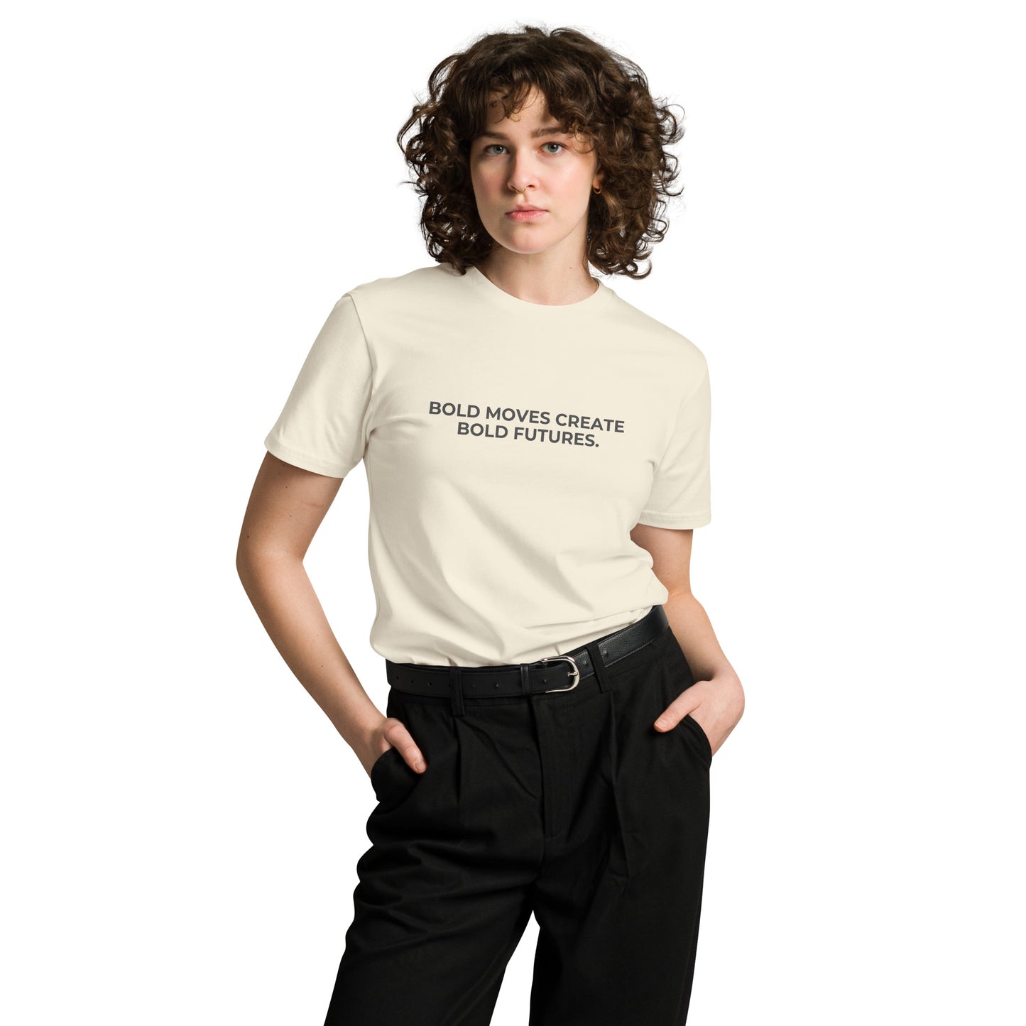 Woman wearing a natural premium tee with "Bold Moves Create Bold Futures" text.