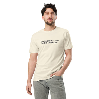 Man wearing a natural premium tee with the text "Small Steps Lead to Big Changes".