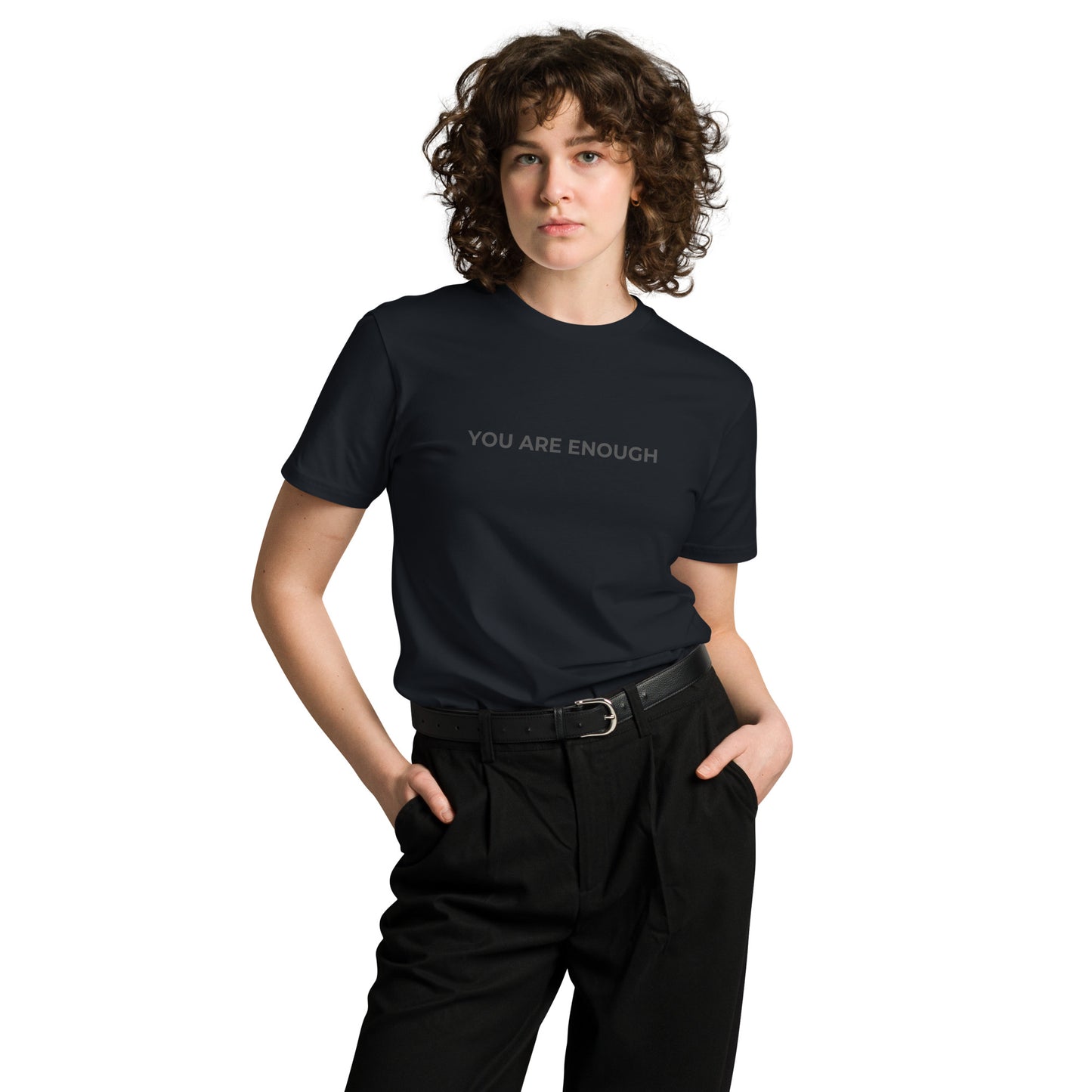 Woman wearing a navy premium tee with "You Are Enough" text.