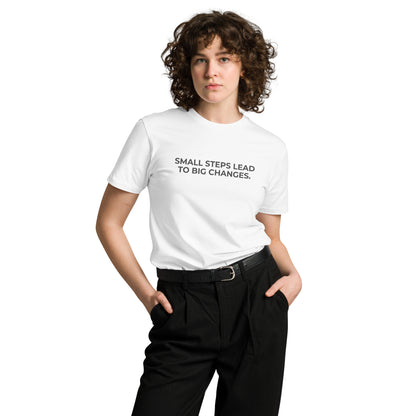 Woman wearing a white premium tee with "Small Steps Lead to Big Changes" text.